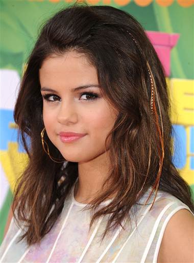 Selena wearing feather hair extensions