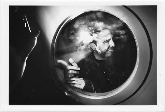 dirty photos - upon - flash street photo of couple through a circular window in nightclub