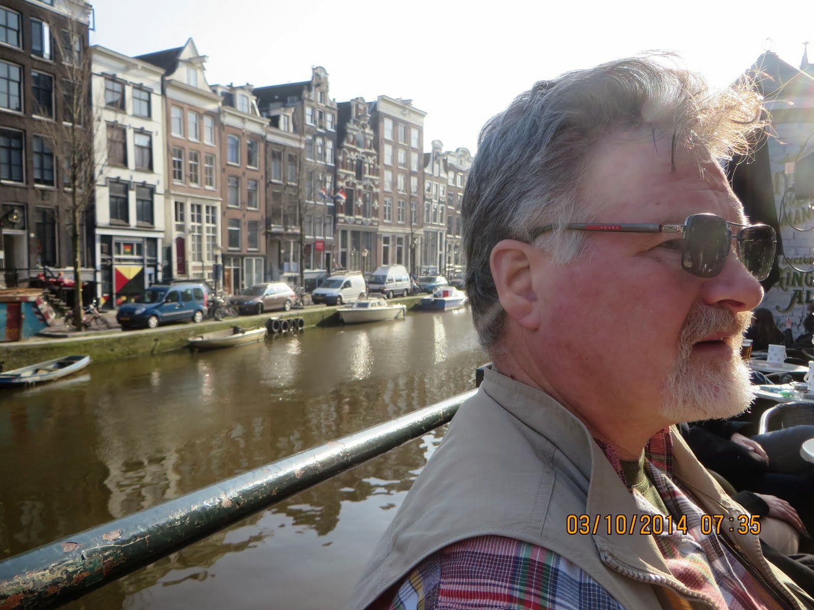 Larry at canal side cafe sampling Amstel on Prinsengracht Street, Amsterdam