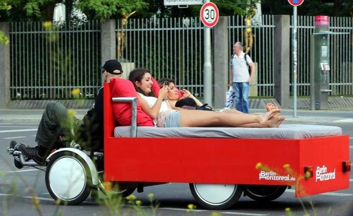 Two women being driven on a 'Bettbike' (bed bike) through Berlin, Germany, on Wednesday. Entrepreneur Richard Eckes and his company Berlin Horizontal offer tours around the capital on the new rickshaw. A one-hour tour costs 45 euros (S$74).