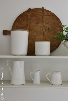 Old wooden chopping board, 'AM.PM' pots and 'Côté Bastide' jug