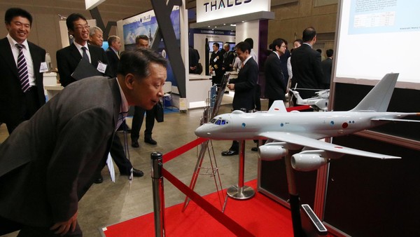 A visitor examines a scale model of Japan's P-1 maritime patrol aircraft A visitor examines a scale model of Japan's P-1 maritime patrol aircraft