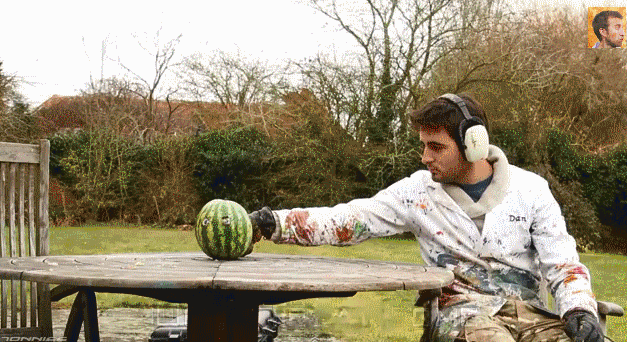 watermelon explodes with guy sitting next to it 