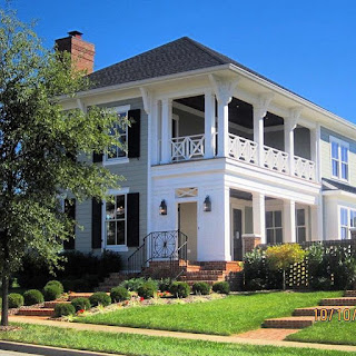 the designer showhouse at norton commons with side porches on two levels and a brick chimney and walkway from the red brick sidewalk