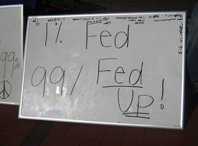 Whiteboard with message 1% fed, 99% fed up