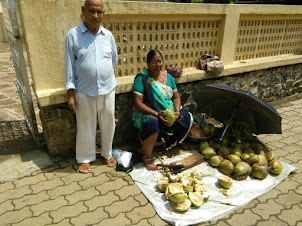 A couple selling Tender coconuts outside the Fire Temple.