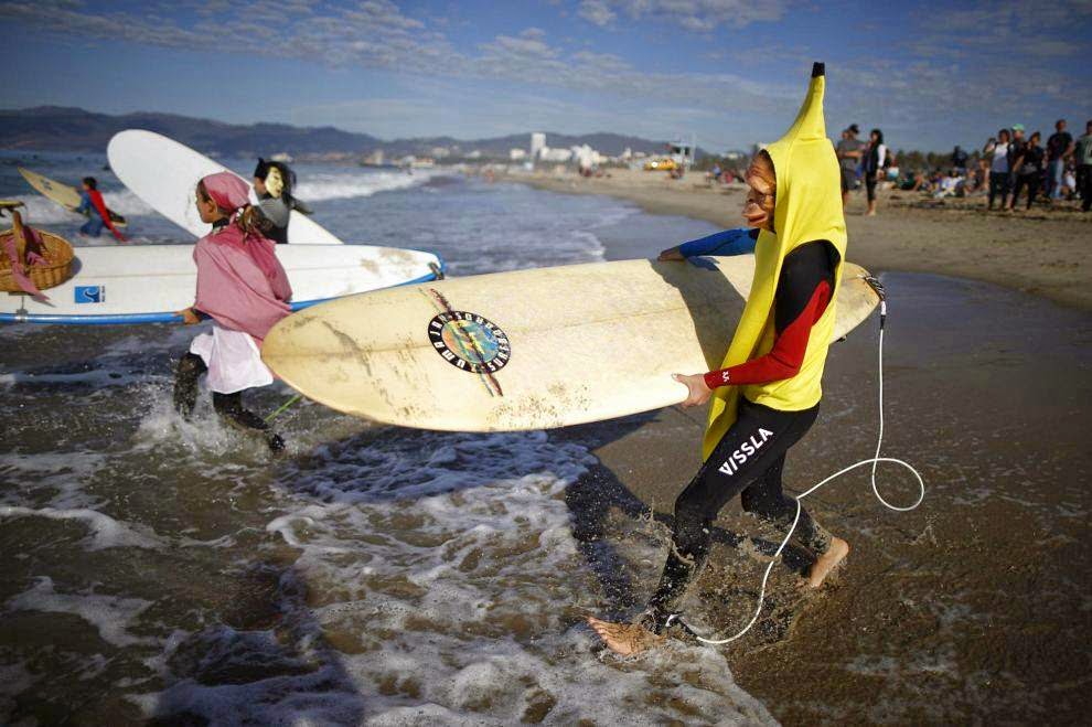 Halloween Surf Contest 2014 Competitors run into the Pacific Ocean during the 7th annual ZJ Boarding House Haunted Heats Halloween surf contest. (REUTERS/Lucy Nicholson)