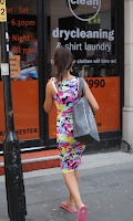 Michelle Keegan in front of a dry cleaning store