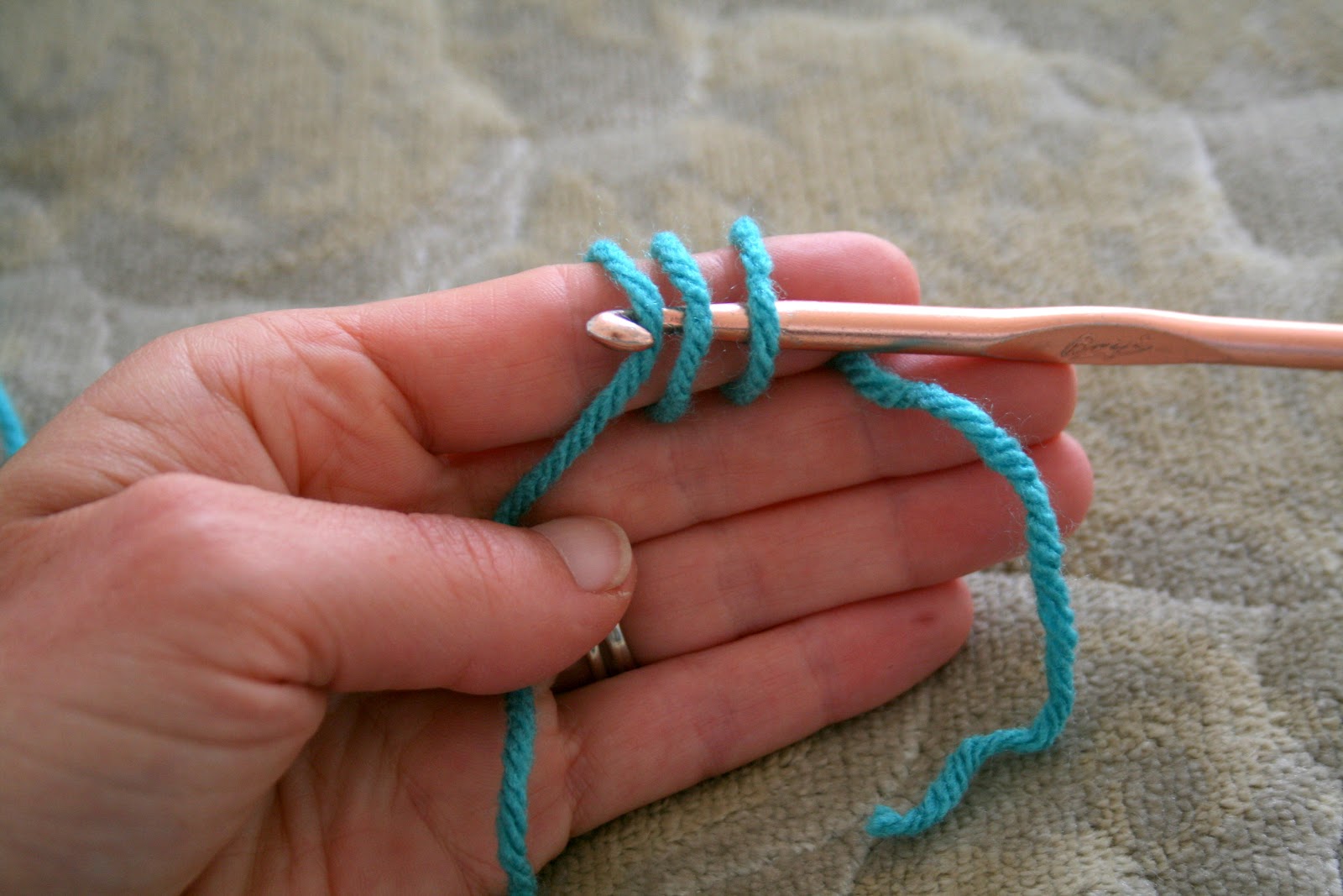 Pull that third strand under the other strands on your finger, and ...