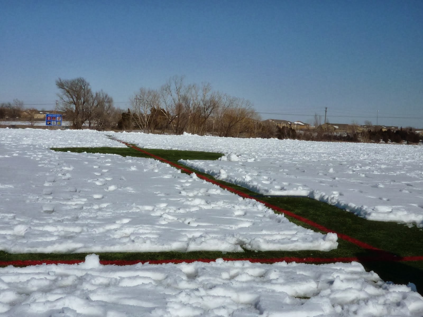They had to shovel the snow to see the lines on the field.