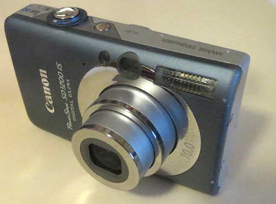 Silver-bodied digital point-and-shoot camera