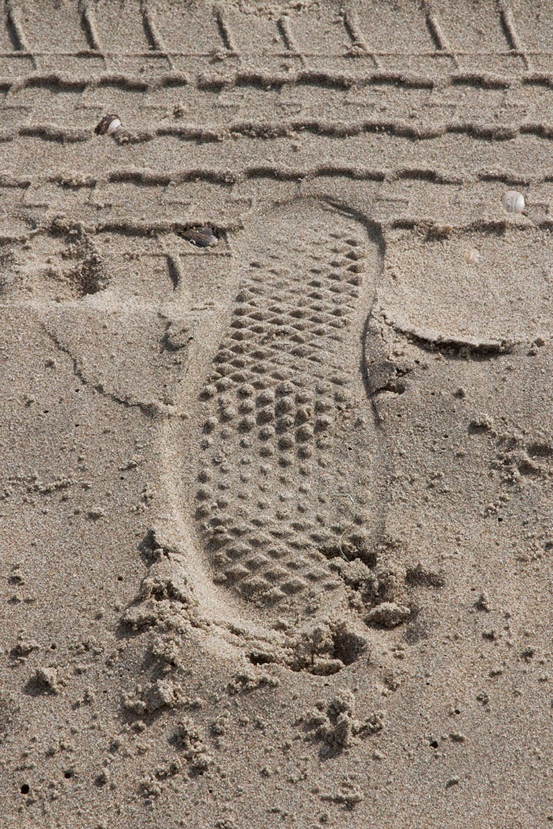 footstep and tyre track in sand