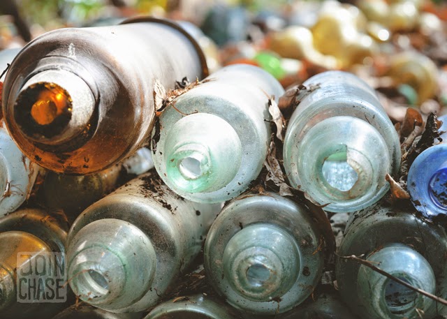 Colorful broken bottles stacked on top of each other around Nagar Glass Factory, Yangon, Myanmar.