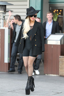 Lady GaGa strikes a pose in a black and mesh bodysuit with fishnet stockings and sky-high pumps
