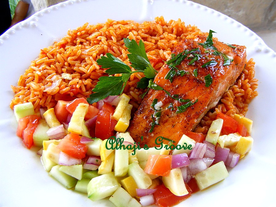 Food and lens Jollof Rice With Grilled Salmon and squash Salad
