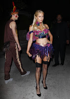 Paris Hilton posing for photographers in a Halloween costume