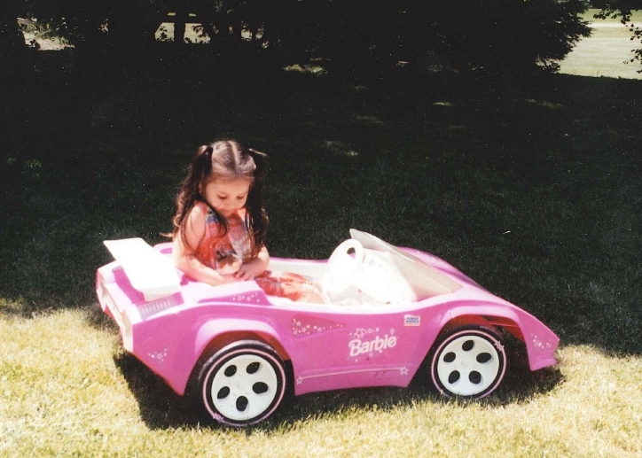 was learning how to drive her little pink sports car around the yard