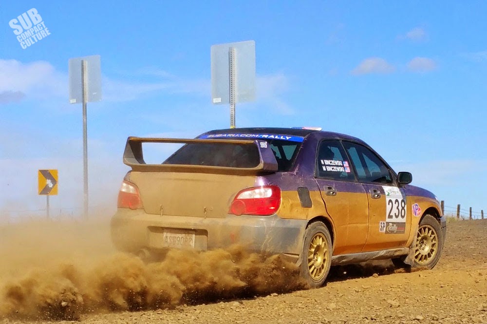 Subaru kicking up dirt at rally
