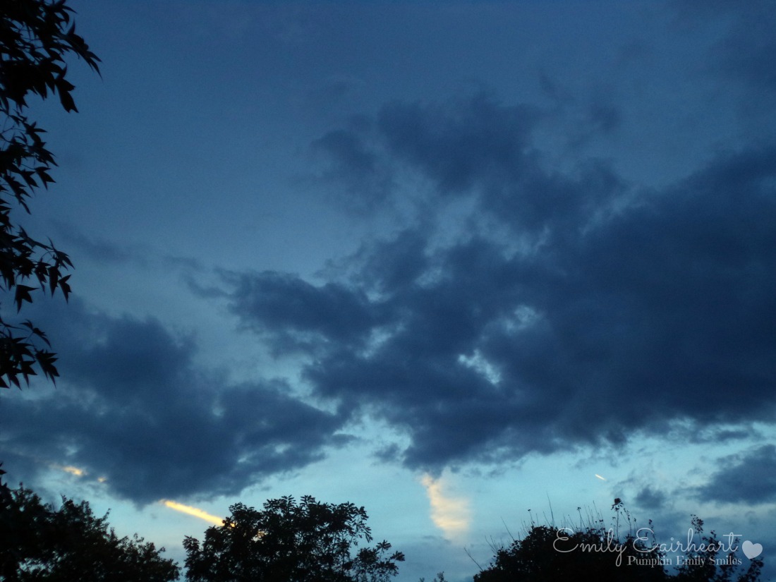 Dark clouds that look like two hands reaching towards each other.