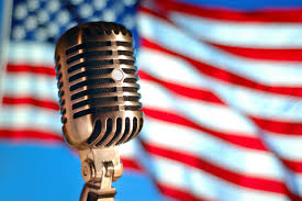 Old-fashioned microphone with American flag behind