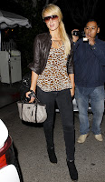 Paris Hilton wearing tight denim pants and leopard print shirt