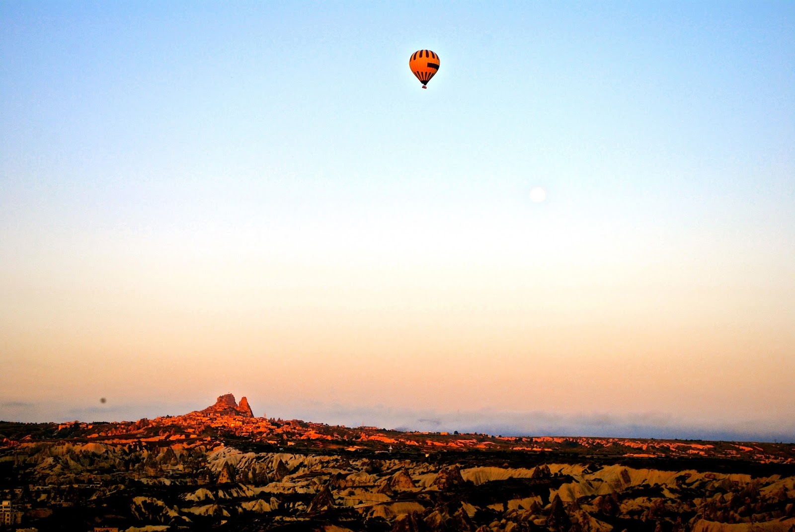 Hot Air Ballooning over Uchisar Castle in Cappadocia at Sunrise with Butterfly Balloons