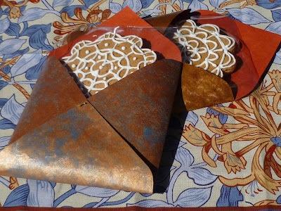 handmade favor envelop with decorated gingerbread cookie