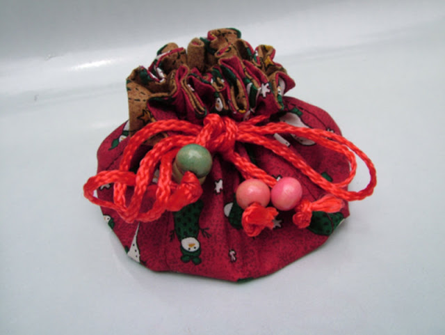 handmade circular jewelry pouch with multiple pockets