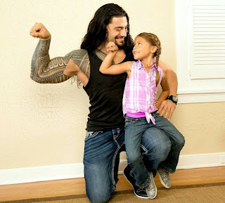 Roman Reigns and Daughter flexing their guns Roman Reigns and daughter flexing biceps