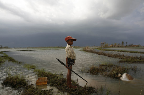 A boy whose house was destroyed by the cyclone watches an approaching storm A boy whose house was destroyed by the cyclone watches an approaching storm