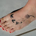 Flying black birds and black flying dandelion tattoo on foot