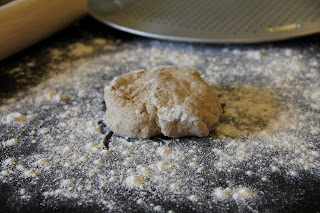 pizza dough on floured surface