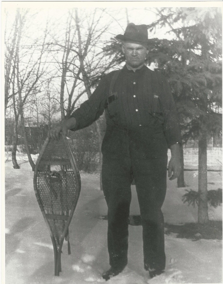 Dad holding snowshoes -- circa 1940