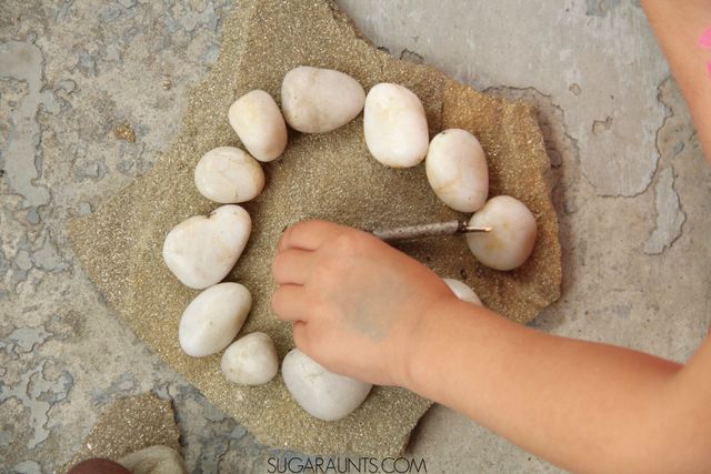 Learn with rocks, including teaching kids to tell time, math, literacy, fine motor, sensory.