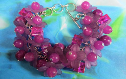 Vintage Style Glam Bracelet Dramatic bracelet has clusters of square, round and shiny magenta flower beads