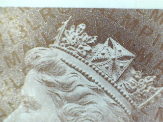 Close up of 5p Machin stamp showing security codes.