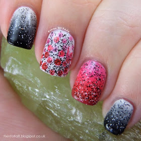 Gradiated mani in shades of black, grey, and white, and three different pinks, with a dotted gradient accent and black and white confetti glitter.
