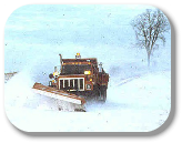 County snow plow in winter blizzard