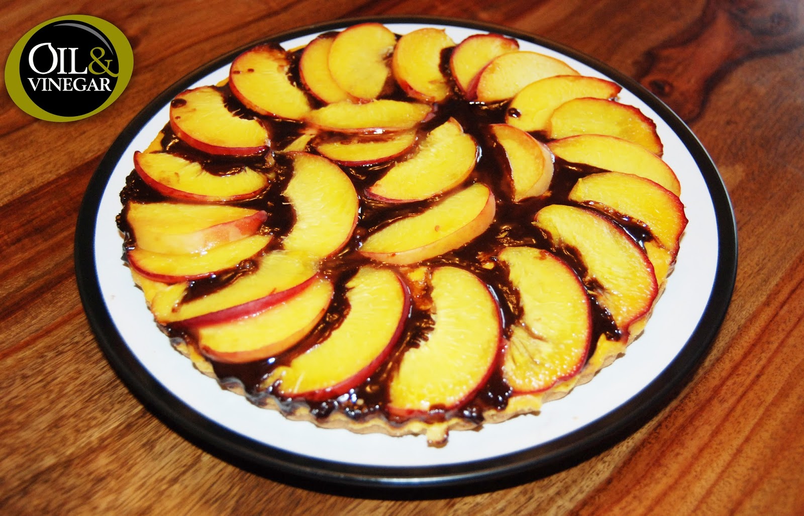 Oil & Vinegar UK Homemade peach tart with a chocolate sauce and