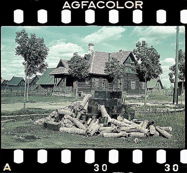 A pile of discarded wicker artillery shell packing cases and ammunition boxes. Based on their three-tone camoflague, the boxes are either prewar dated or constructed after February 1943. As these were likely used during the invasion I would lean towards the former. A pile of discarded wicker artillery shell packing cases and ammunition boxes. Based on their three-tone camoflague, the boxes are either prewar dated or constructed after February 1943. As these were likely used during the invasion I would lean towards the former.