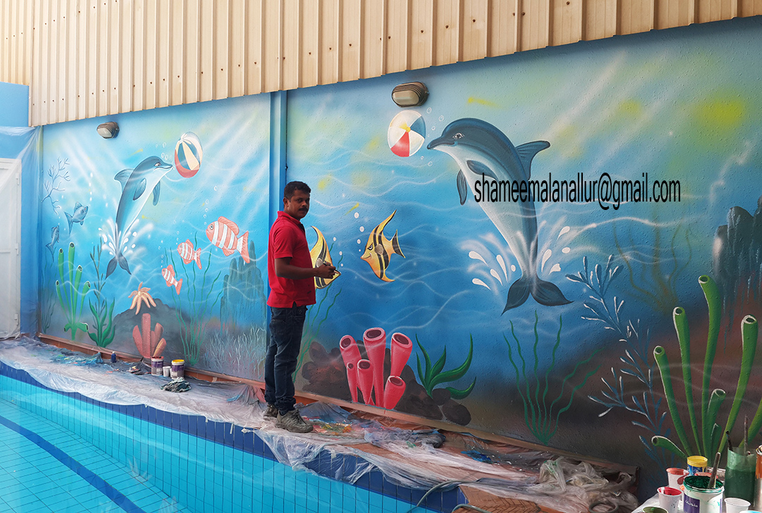 Creative Artist. Shameem dolphin fishes.painting on swimming pool wall