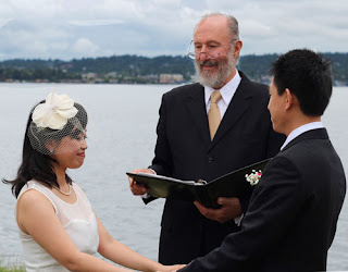 Kent Buttars of A Heavenly Ceremony officiates for Shanshan and Wei Shanshan and Wei hold hands while Kent Buttars of A Heavenly Ceremony officiates