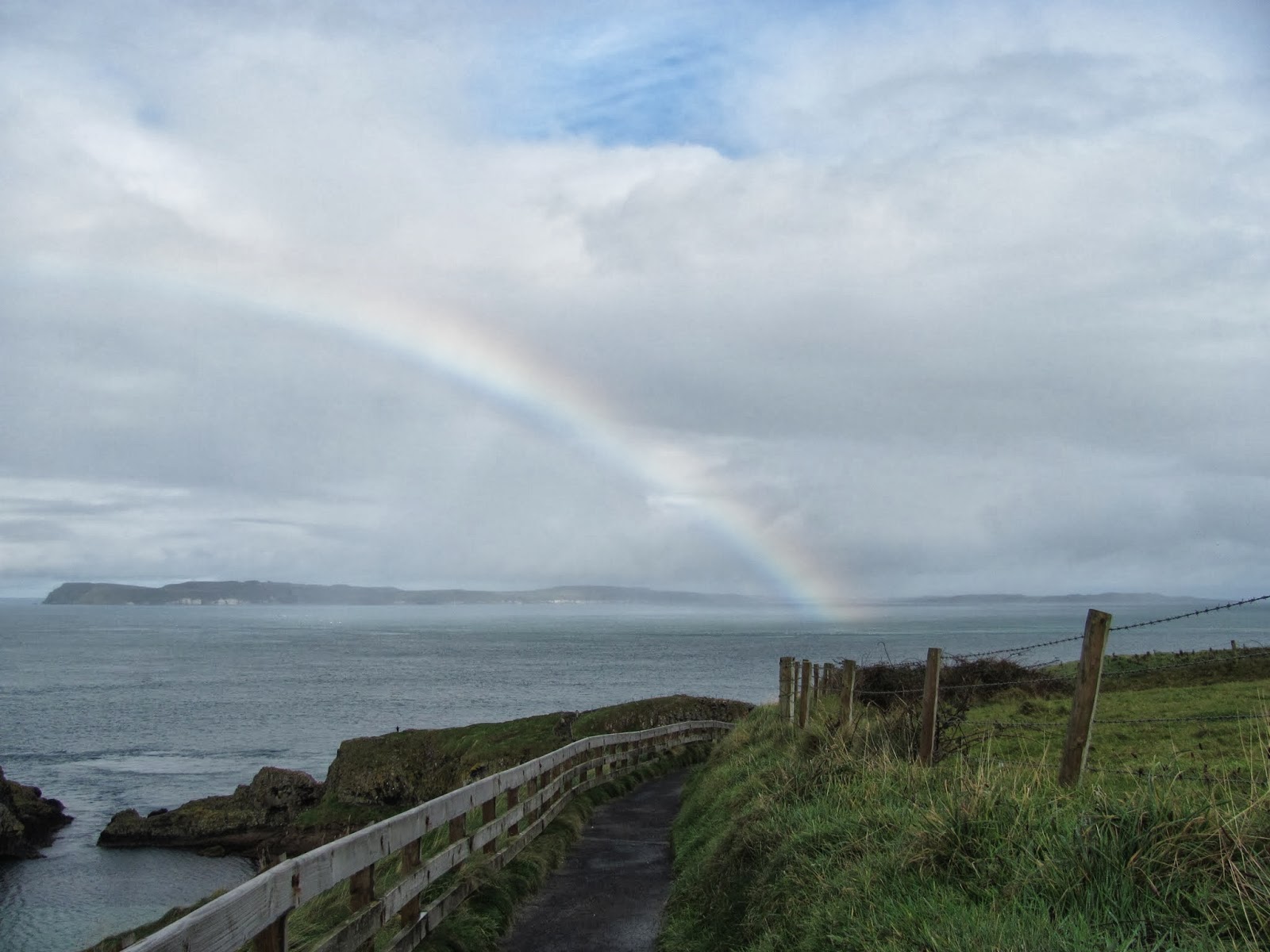 A Rainbow A rainbow stretches to the sea at Carrick-A-Rede Rope Bridge Northern Ireland