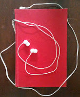 Hardcover book with earbuds.