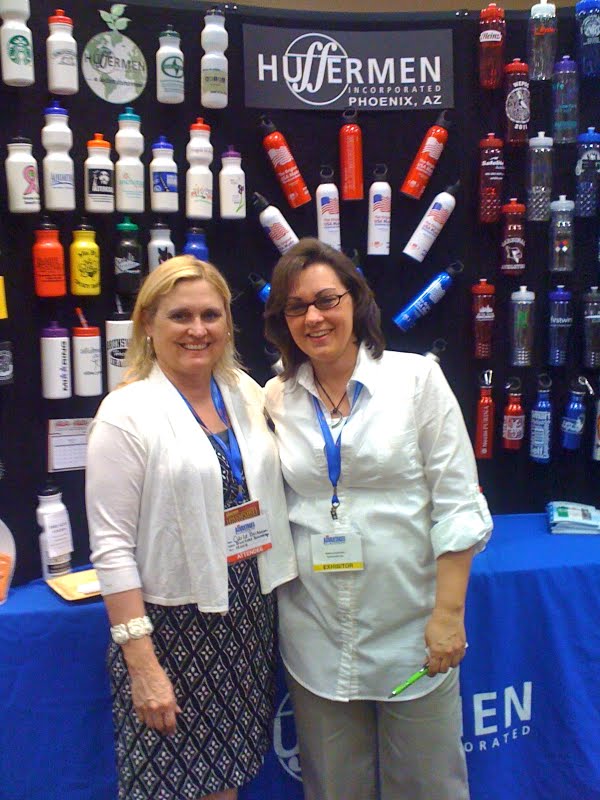 Image is of Carla Buchanan, Business Brandings, ASI number 152018, visiting the Huffermen booth, at the ASI Roadshow in Las Vegas, May 6, 2011.