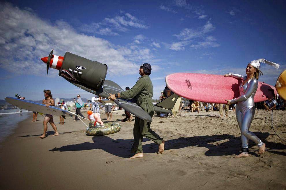 Halloween Surf Contest 2014 Competitors run into the Pacific Ocean during the 7th annual ZJ Boarding House Haunted Heats Halloween surf contest. (REUTERS/Lucy Nicholson)