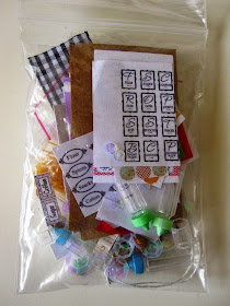 Small ziplock bag filled with tiny dolls' bottles and a selection of printies for making miniature jars.