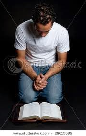 man+kneeling+in+front+of+Bible.jpg