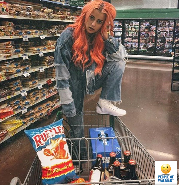Her hair matches her bag of cheese puffs ~