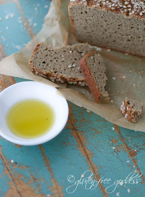 Dipping fresh warm bread in olive oil